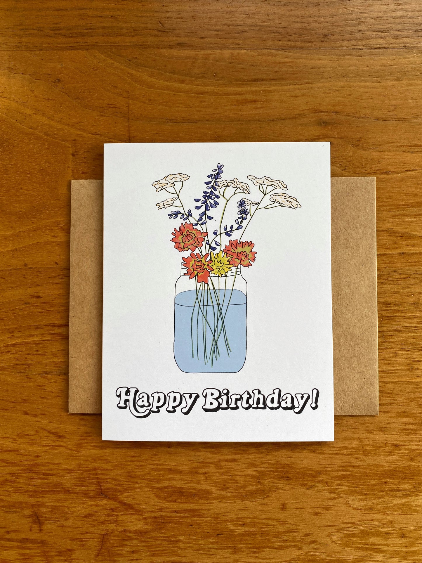 Greeting card with Wildflower bouquet in a mason jar with "Happy Birthday" written underneath.