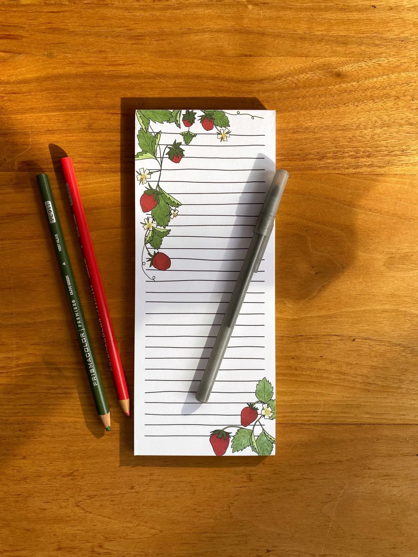 lined notepad with strawberry drawings