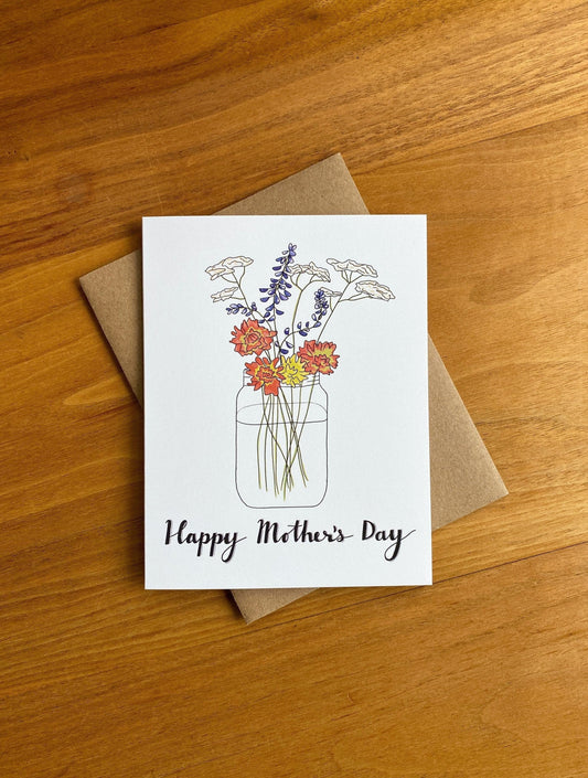 Greeting card with a wildflower bouquet in a mason jar and says "happy mother's day"