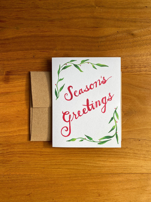 Greeting card with watercolor greenery and "Season's Greetings"