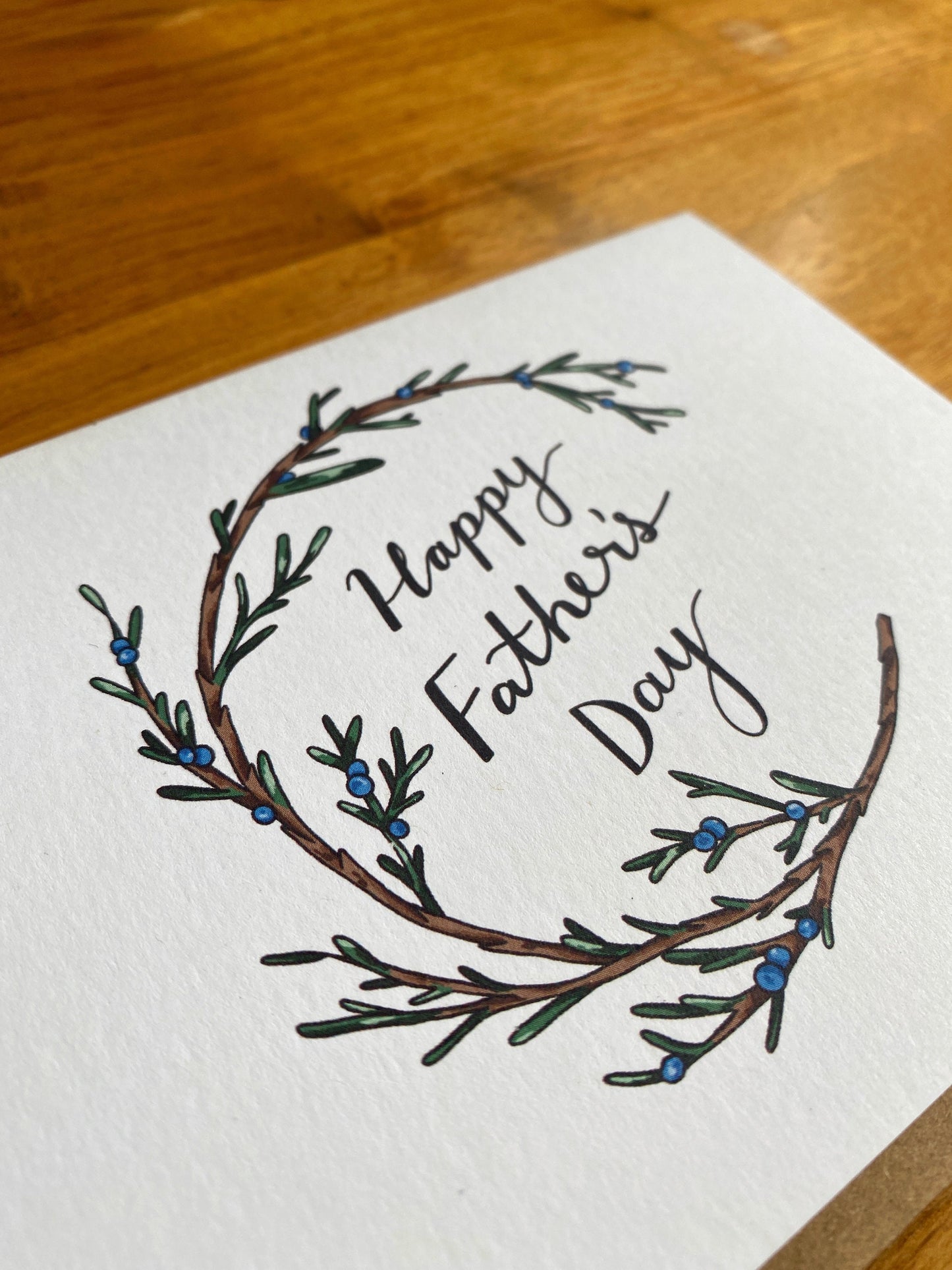 Greeting card with a juniper wreath that says "Happy Father's Day"