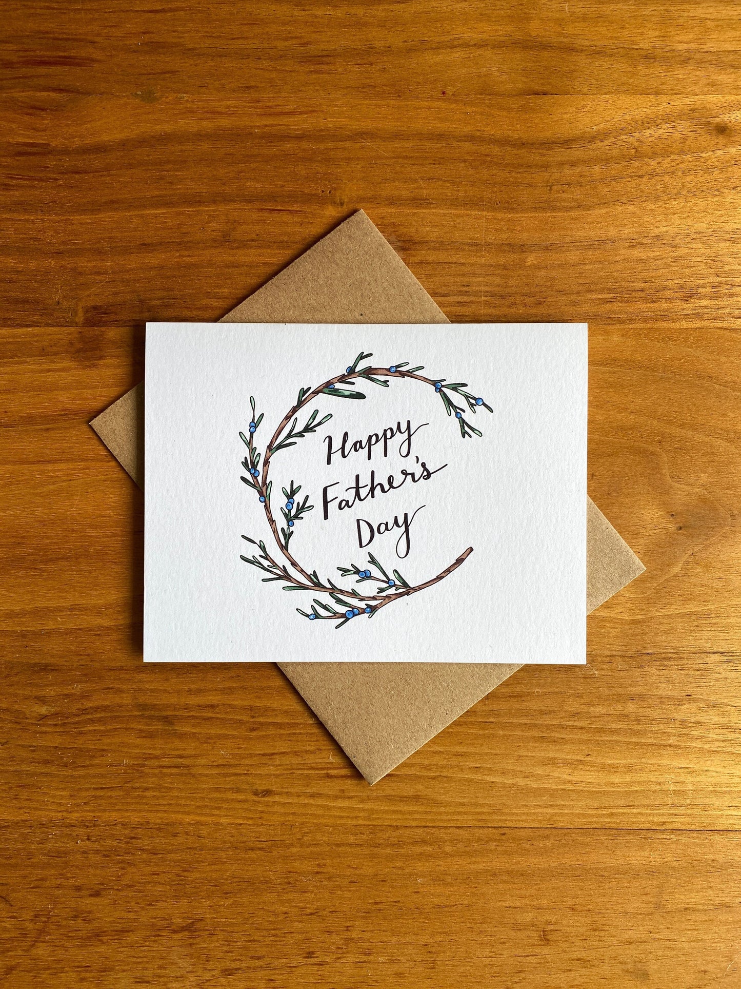 Greeting card with a juniper wreath that says "Happy Father's Day"