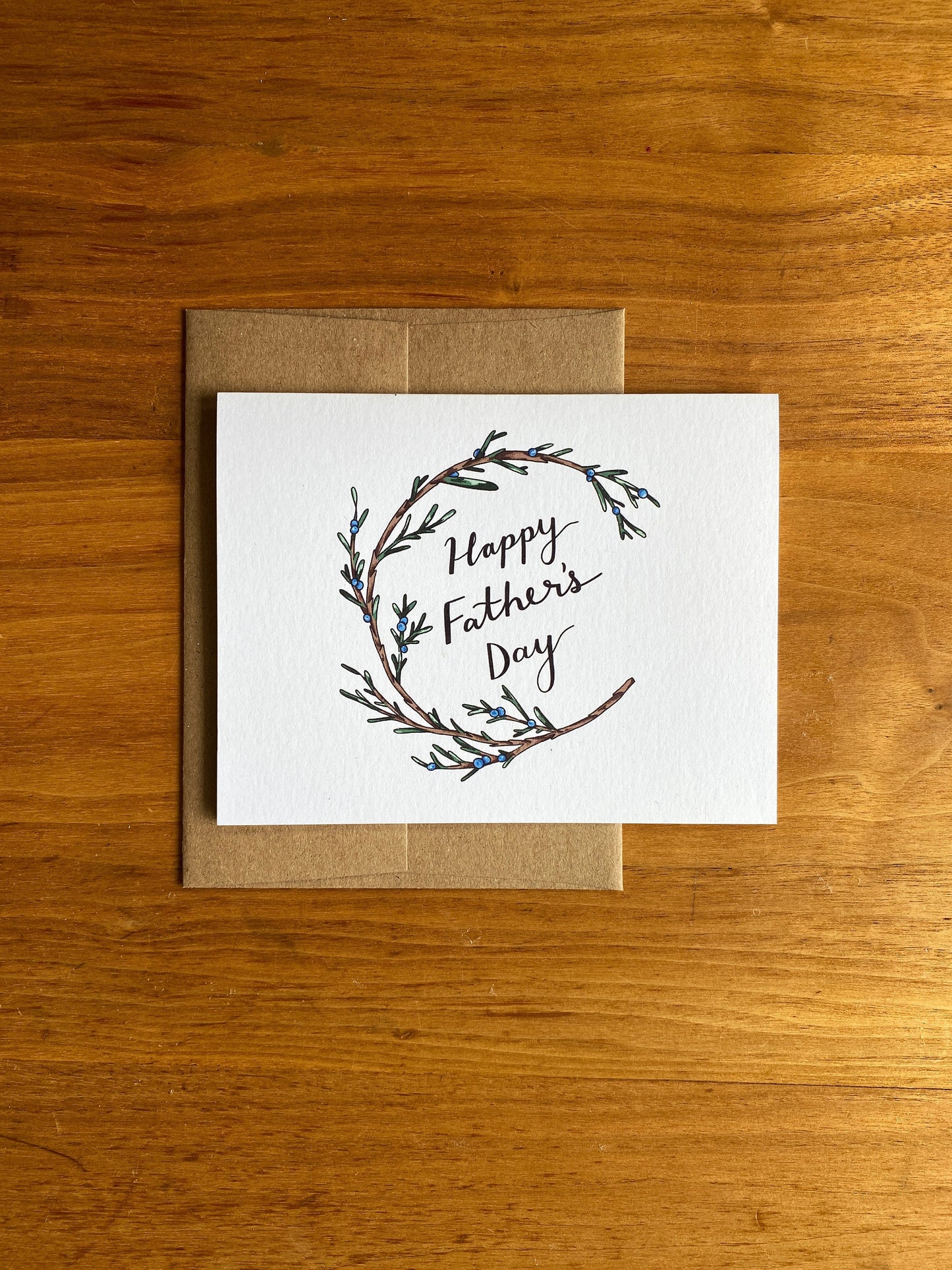 Greeting card with a juniper wreath that says "Happy Father's Day"